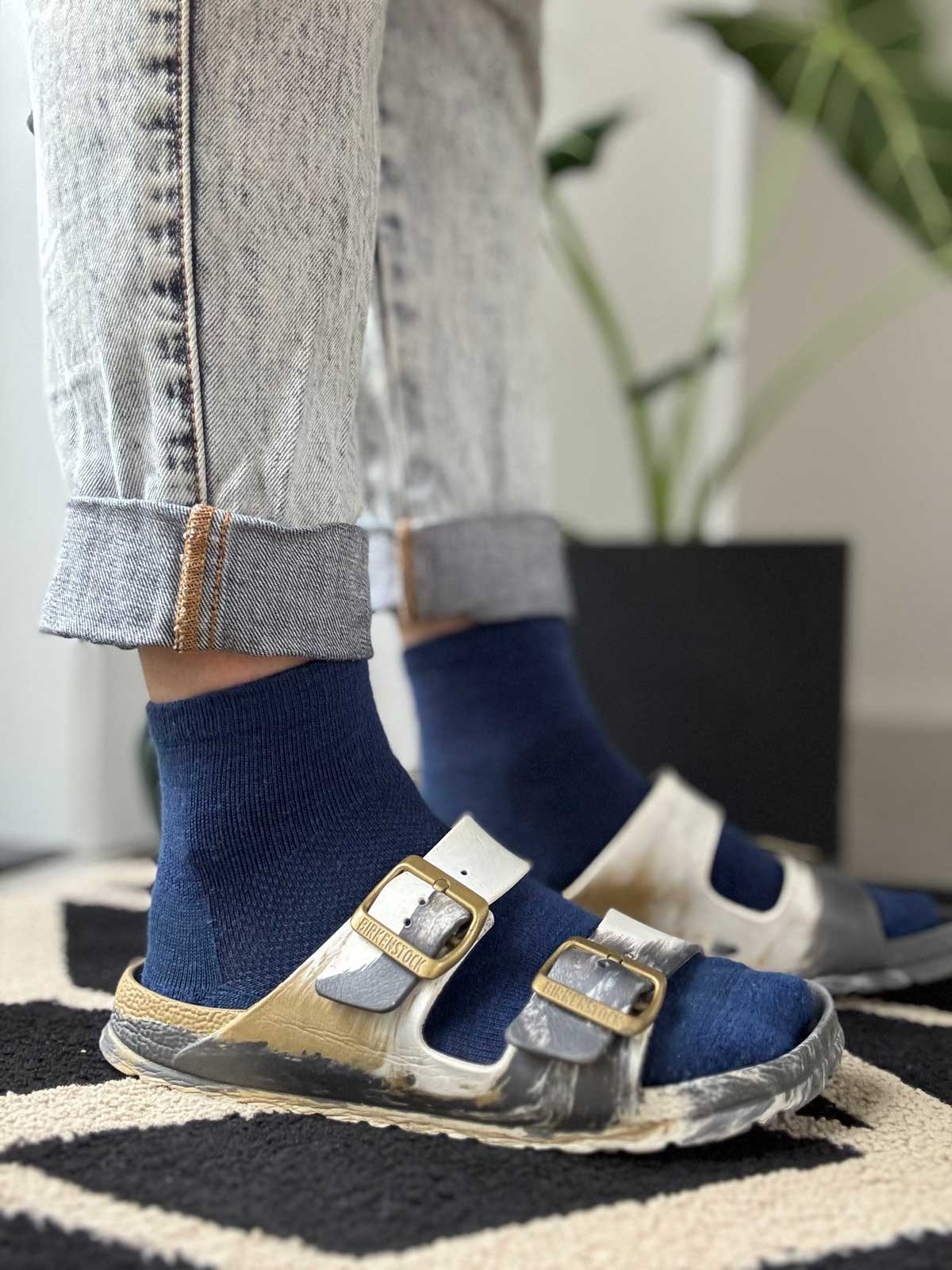 Blue merino ankle socks styled with Birkenstock sandals, casual warm-weather pairing from Merino 365