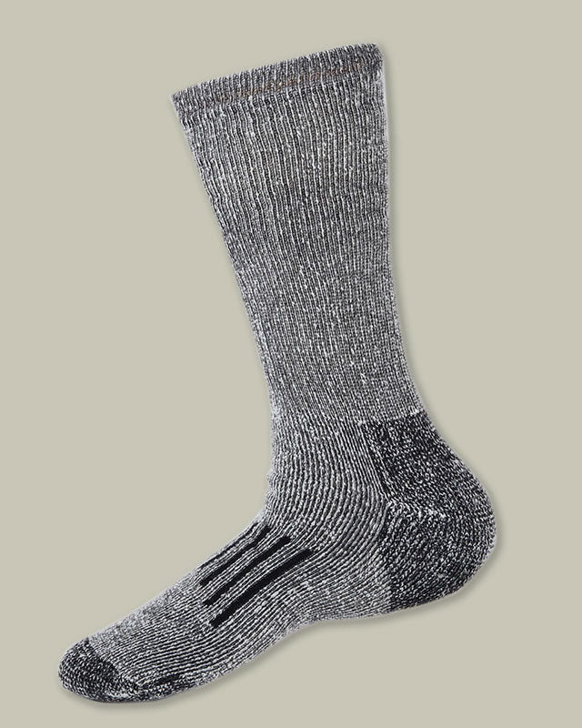 Close-up of black marle merino trekking socks showing ribbed cuff texture and cushioned heel detail