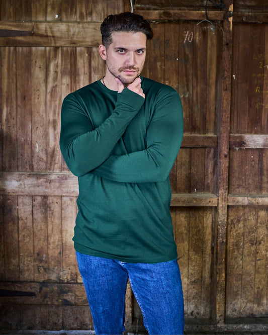 Back view of pine green Merino 365 long sleeve, highlighting the clean seam construction and relaxed shoulder fit.