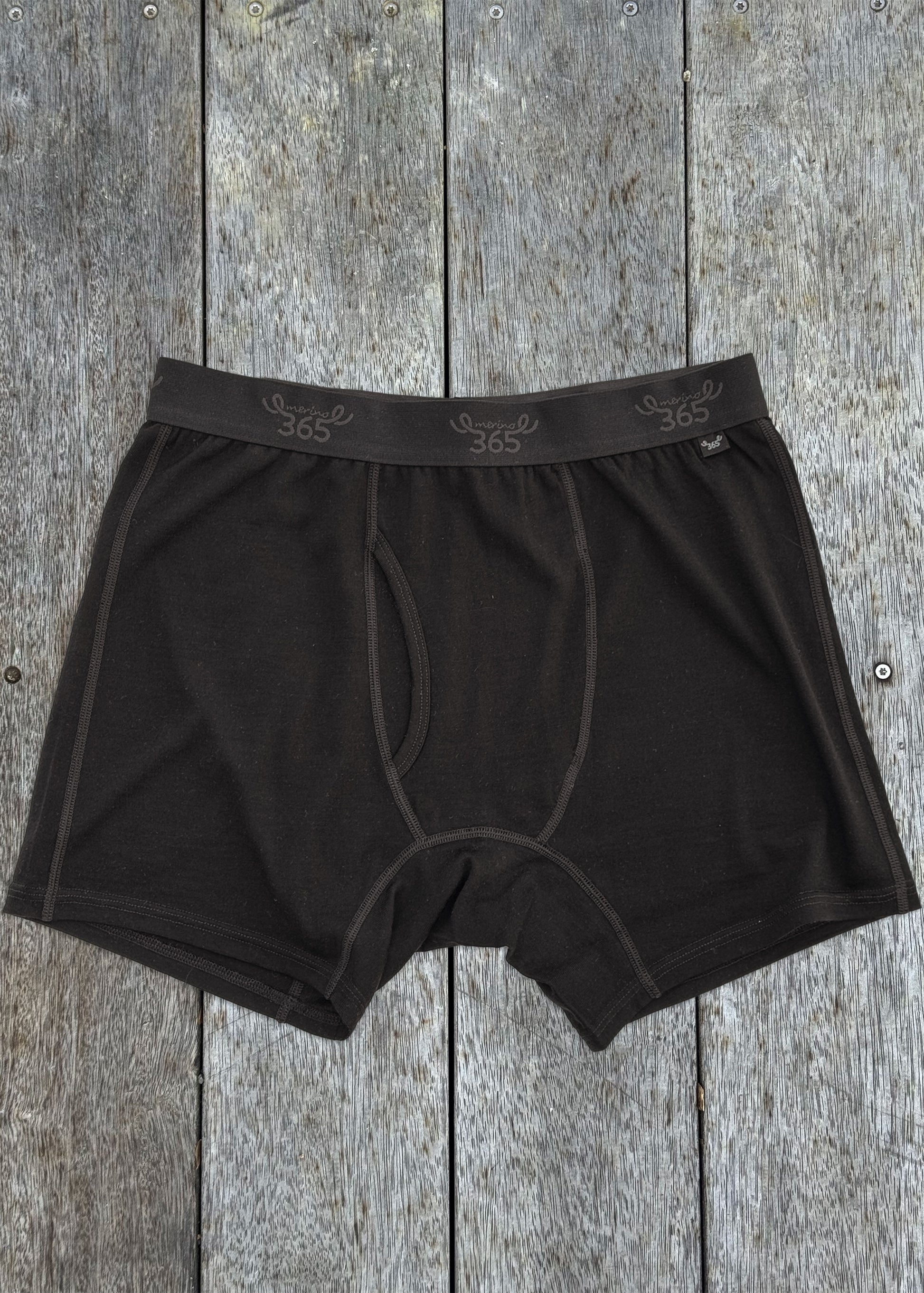 Black merino boxer brief on wood — fitted cut, soft knit, elasticated waistband, Merino 365
