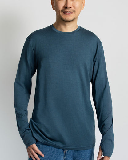 Man wearing a blue merino wool long-sleeve shirt against a white background