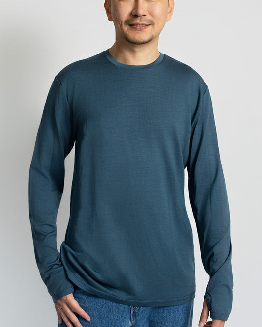 Man wearing a blue merino wool long-sleeve shirt against a white background