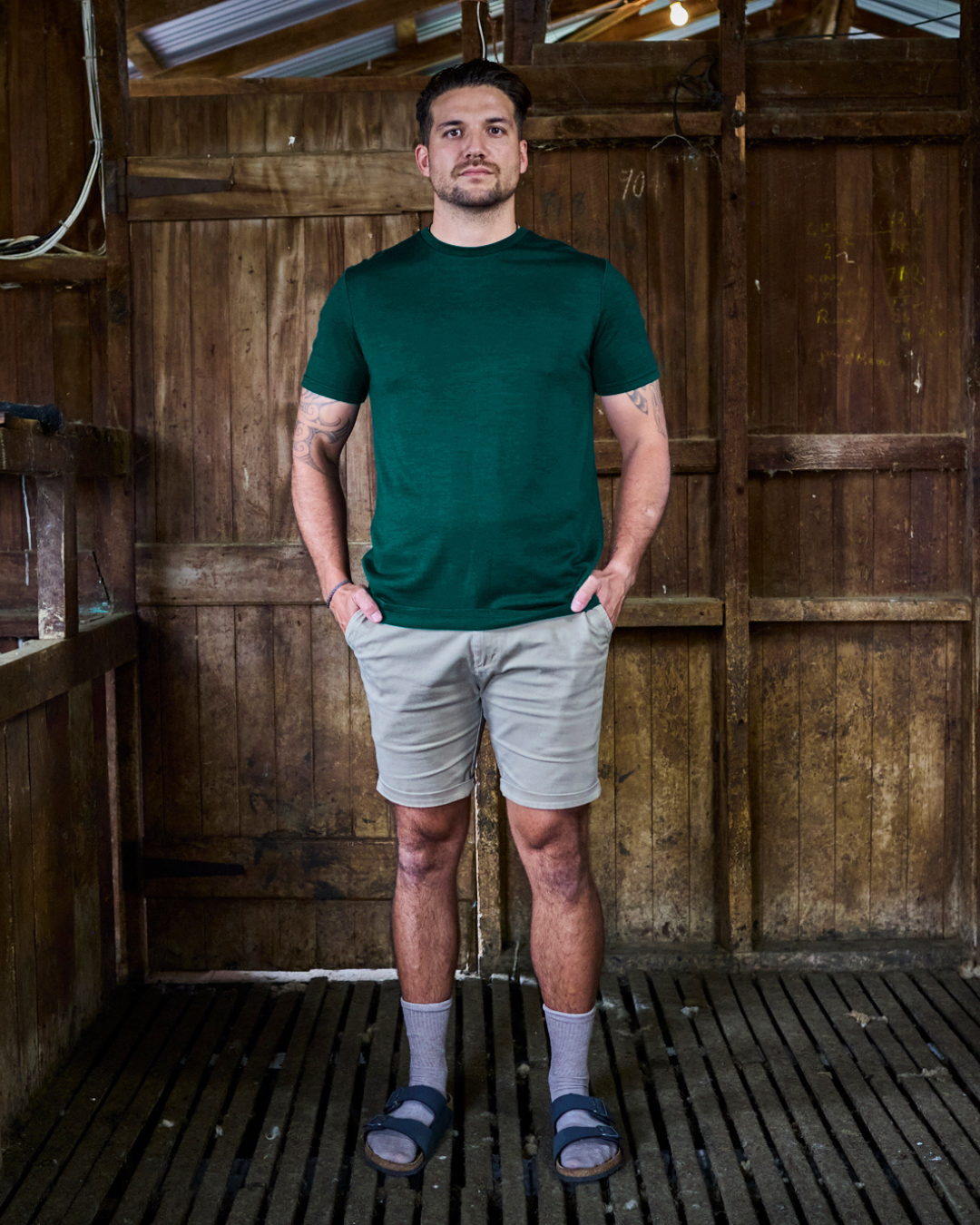 Pine green merino tee worn in natural light — crew neck, short sleeve, relaxed everyday fit by Merino 365