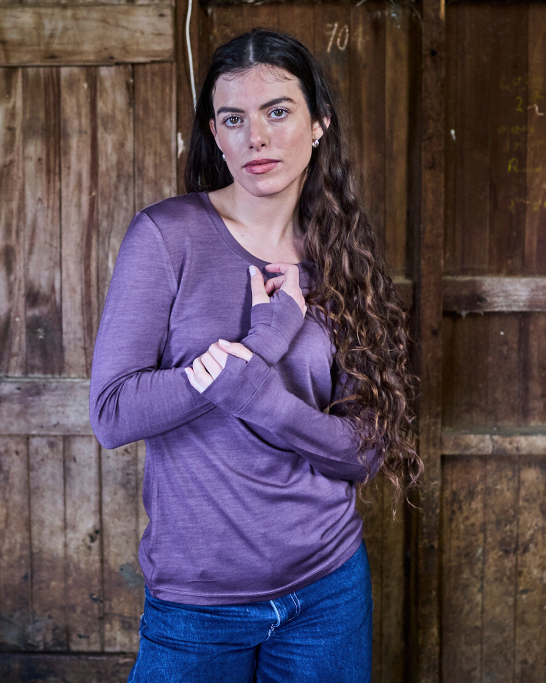 Back view of plum merino wool long sleeve top showing clean seam detail and relaxed shoulder fit
