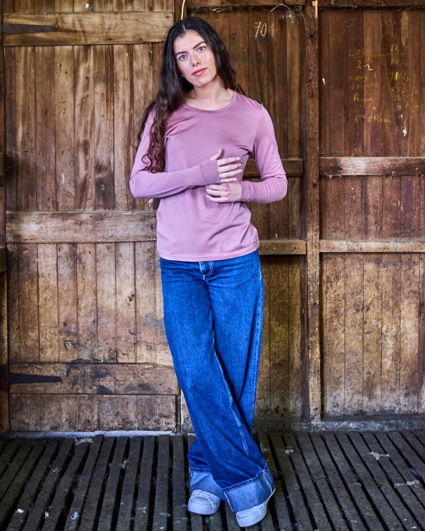 Back view of rose pink Merino 365 long sleeve wool top, fitted silhouette, soft blush tone against neutral background