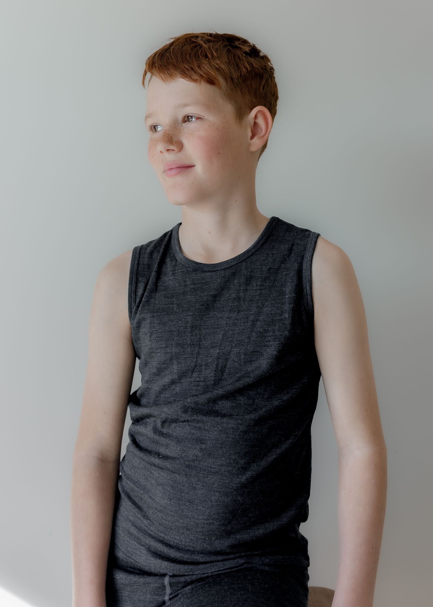 Slate grey youth merino singlet by Merino 365 — fine-knit wool, relaxed fit, ribbed crew neckline.